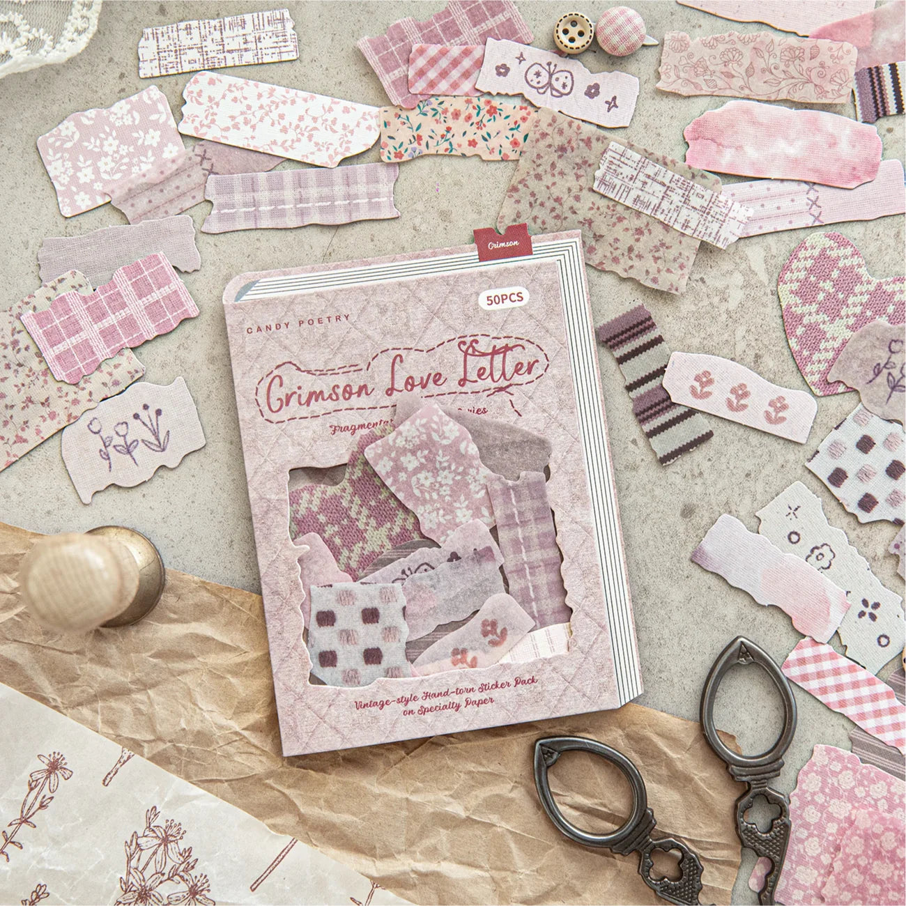 The Crimson Love Letter pink fabric scrap sticker box surrounded by scattered floral and plaid faux-cloth sticker pieces, antique scissors, and craft paper for romantic Cottagecore layering.