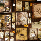 A rich flat lay showcasing the 153-piece vintage journaling kit contents. Features distressed background papers with delicate white lace patterns, butterfly washi stickers, vintage clock faces, and antique tags on a wooden desk.