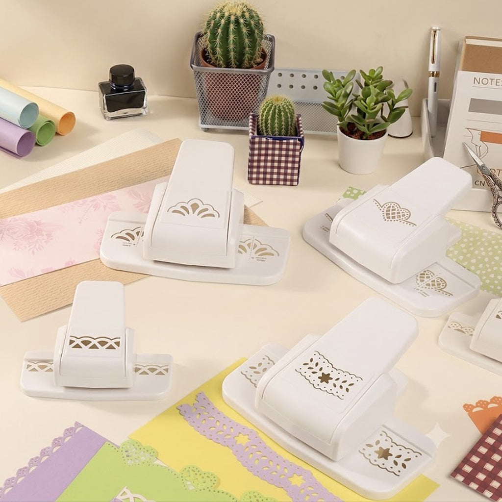 White border punch collection on desk with cactus ink bottle and pastel paper strips