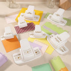 Lace border punch flatlay on cream desk with purple green and orange paper samples