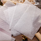 Green-toned embossed vellum paper with leaf relief texture for translucent journal overlays