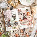 Vintage journal spread decorated with Falling Blossoms dusk-toned floral stickers – warm orange and brown colorway in use