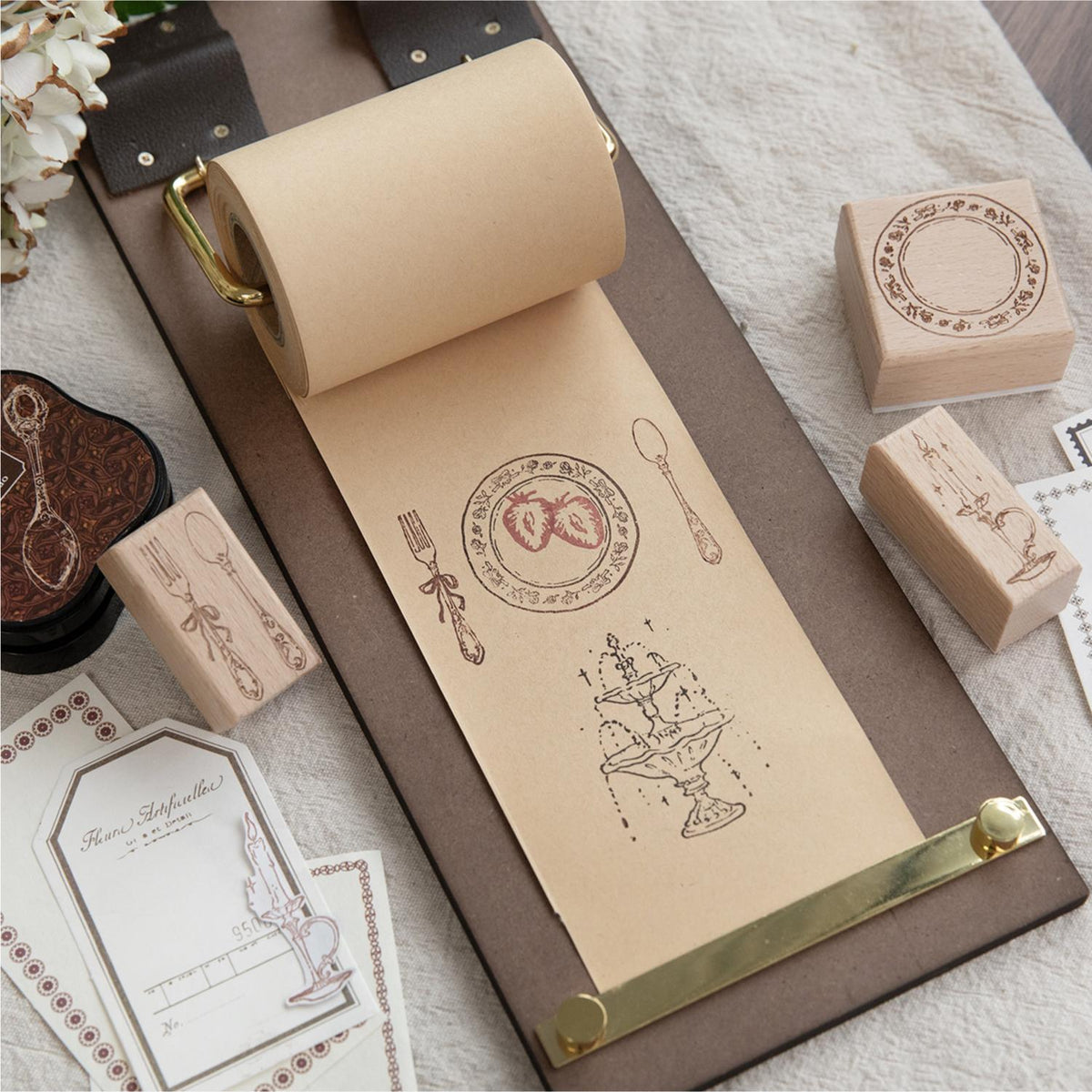 Wooden stamp in a desk tray with twine and tags – vintage journaling desk setup