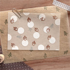 Pinecone and pine tree rubber stamp impressions on kraft paper with white circle labels, brown ink.