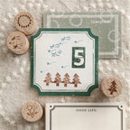 Star-shaped wooden stamp with blue ink impressions on leather-bound journal page, crisp lines.