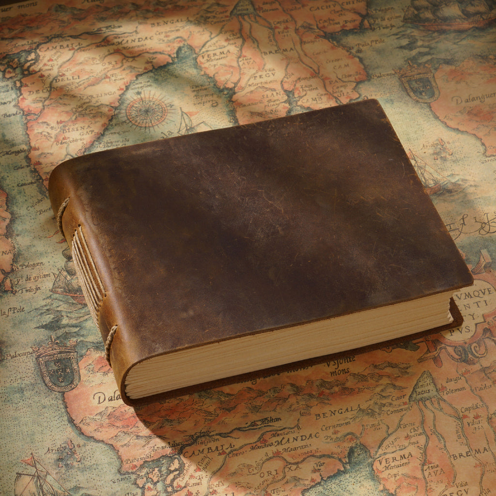 Dark brown carved leather sketchbook with embossed cover on map