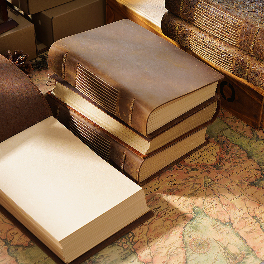 Stack of hand-stitched leather sketchbooks with thick kraft page blocks