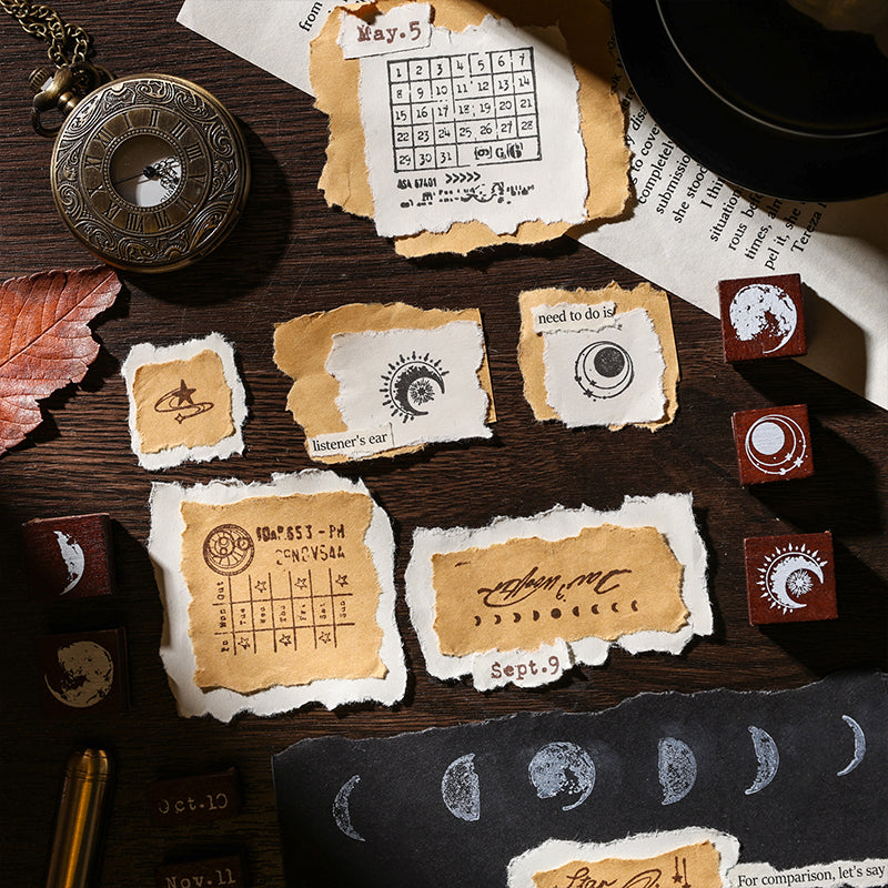Detailed close-up of various stamp impressions on torn kraft paper and black cardstock. Showcases the celestial moon phases, shooting stars, and vintage postmark designs perfect for aesthetic scrapbooking and penpal mail.