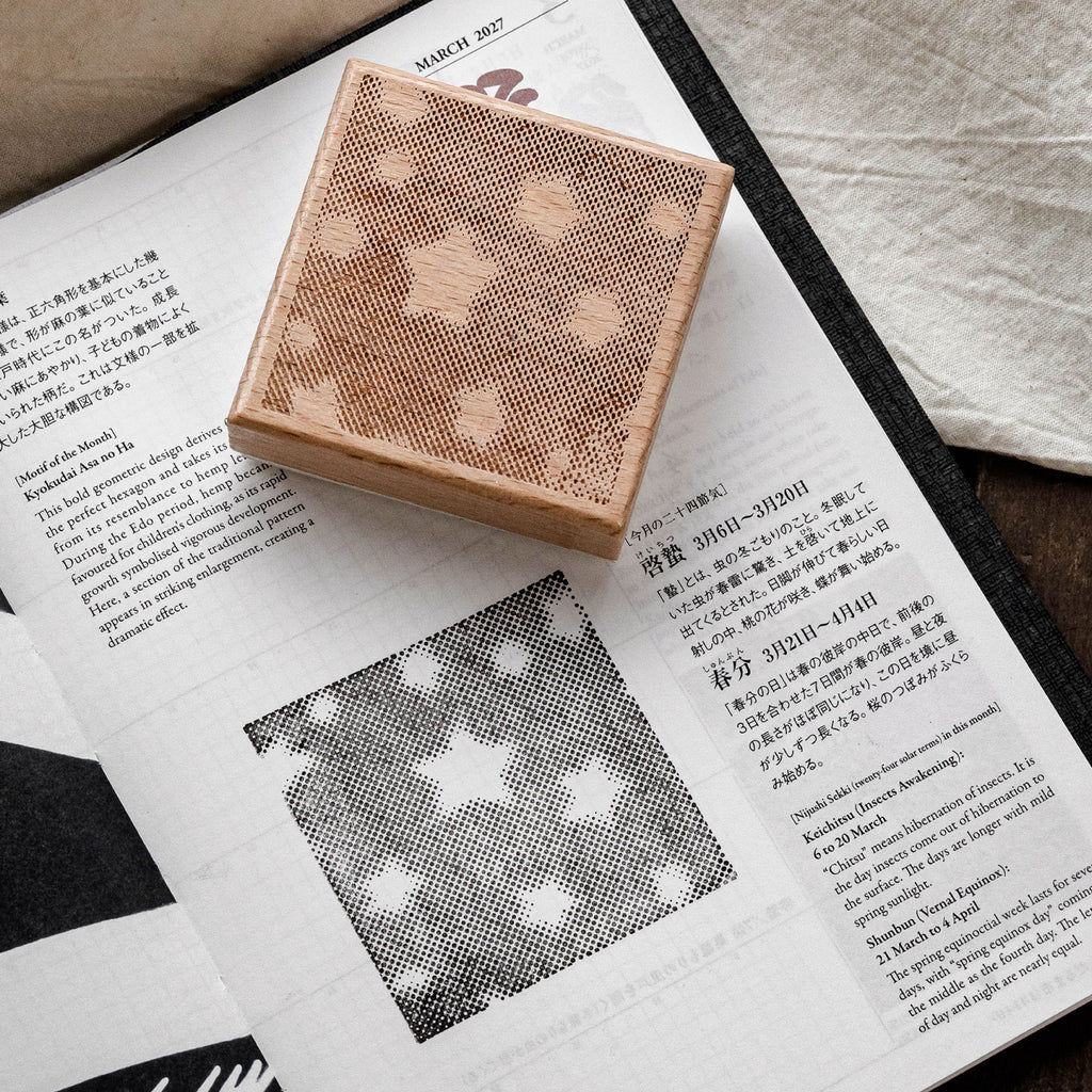 Star grid romantic background stamp on open magazine page, geometric dot pattern printed in black ink.