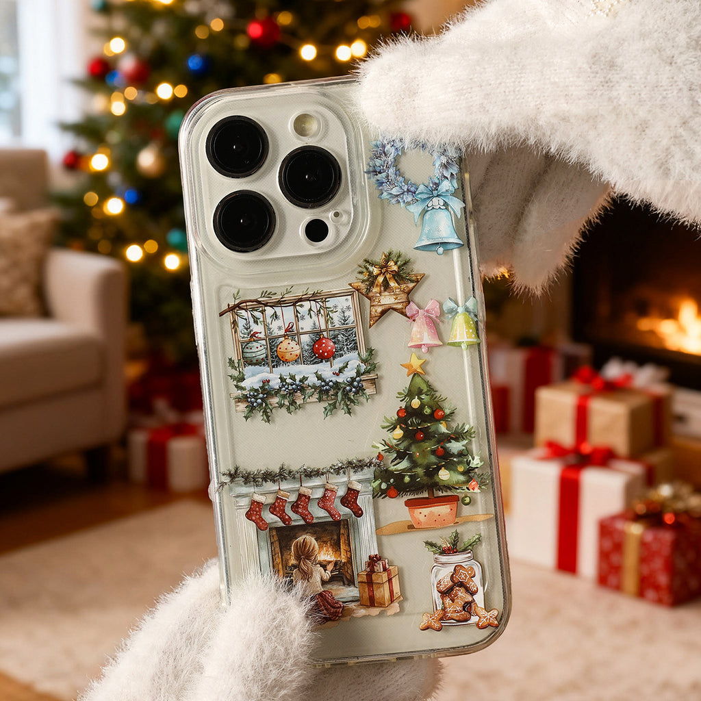 Snowbell's Wish stickers decorating a phone case beside a Christmas tree