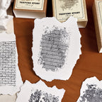 texture story stamp impressions on deckle edge paper stone and text patterns