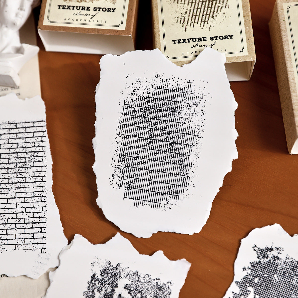 texture story stamp impressions on deckle edge paper stone and text patterns