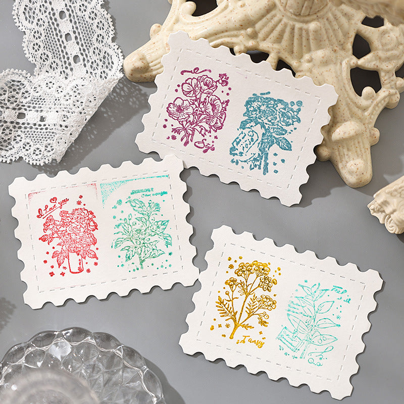 Butterfly and snowflake stamp impressions on white cards with lace doily