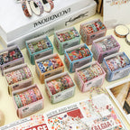 A complete collection of the 12 Summer Flowers botanical washi tape sets arranged on a desk. Each mini box contains 5 rolls of aesthetic floral and fruit masking tape for journaling.