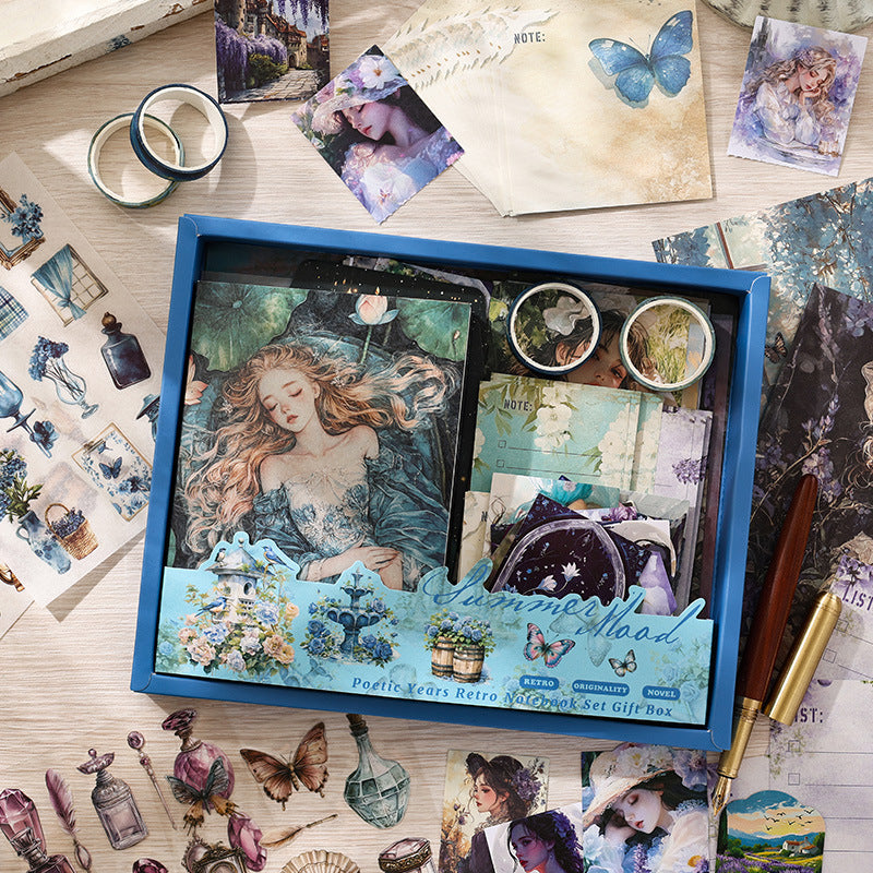 A comprehensive contents layout of the Summer Mood 'Starlit Ocean' aesthetic journal kit. Shows the open blue gift box filled with an A6 notebook featuring a water maiden oil painting, translucent vellum papers, blue-toned PET stickers, washi tapes, and celestial ephemera for junk journaling.