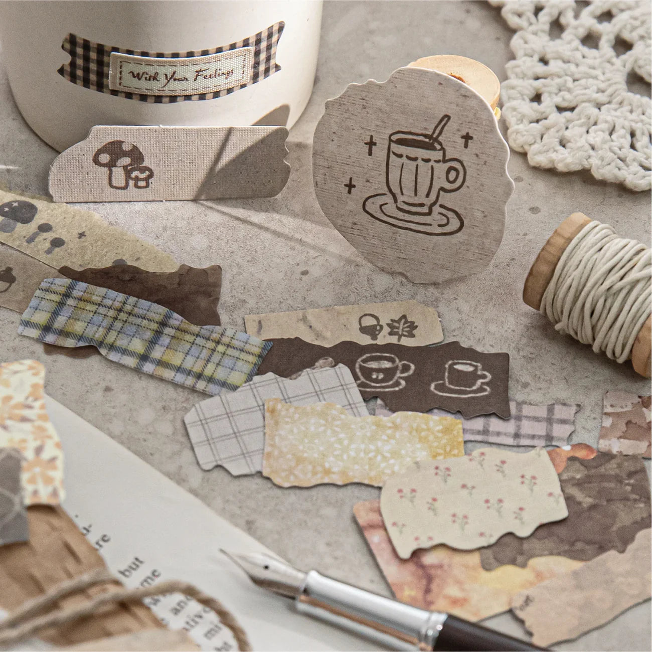 Close-up of the Sunset Says Goodbye sepia brown faux-cloth stickers featuring coffee cups, plaid, and vintage text, beautifully styled with a fountain pen for Dark Academia scrapbooking.