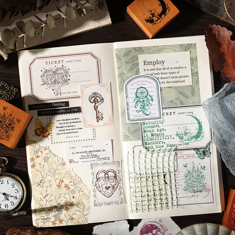 A curated top-down view of eight intricately detailed Dreams Under the Moon wooden stamps neatly arranged on a wood surface. Motifs include a mystical moon rabbit, a detailed pocket watch, an ornate key, a heart lock, a dreamcatcher, and gears.