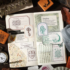 A curated top-down view of eight intricately detailed Dreams Under the Moon wooden stamps neatly arranged on a wood surface. Motifs include a mystical moon rabbit, a detailed pocket watch, an ornate key, a heart lock, a dreamcatcher, and gears.