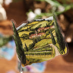 Along the Way edition travelogue sticker tin in hand – green countryside scenes on translucent PET stickers