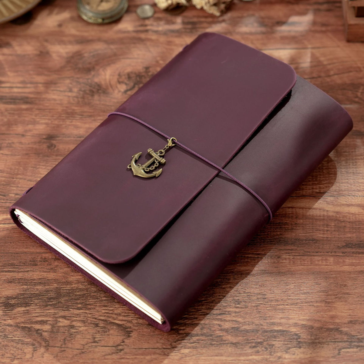 Dark purple A5 trifold leather notebook with brass anchor and cord wrap