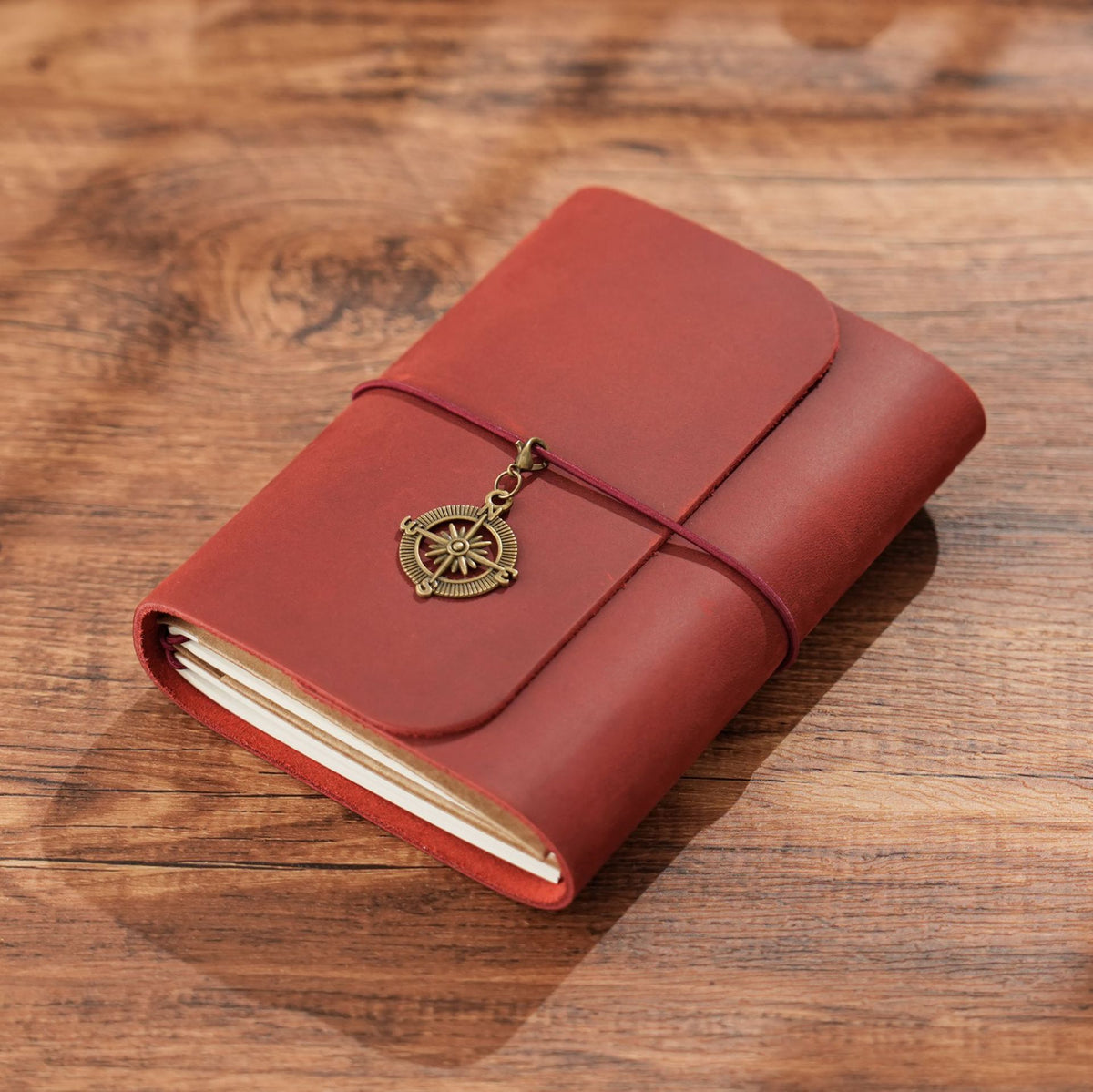 Wine red trifold leather notebook with elastic wrap closure