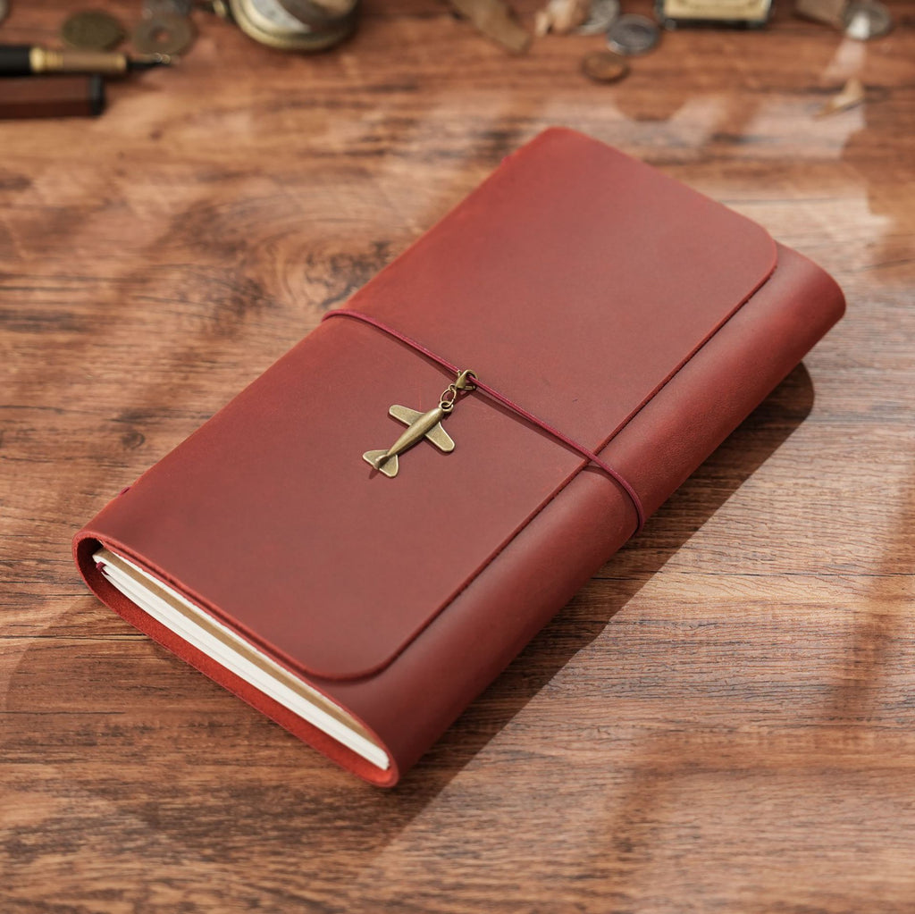 Wine red trifold leather notebook with elastic wrap and brass sword charm