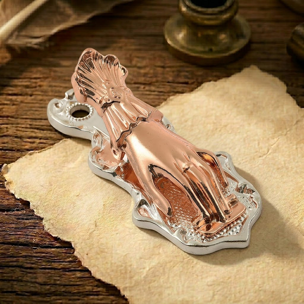 A charming two-tone metal journal clip. The detailed Victorian Lady's Hand (no pearl) is finished in a warm polished silver, contrasted by the delicate rose gold finish on the intricate lace-cuff wrist. It is clamping a small bundle of colorful and delicate vintage papers.