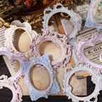 Vintage journal spread with 3D embossed frames layered over butterfly stickers and floral ephemera