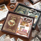 Display of the vintage butterfly aesthetic journal gift box collection, showing both the Nature's Whispers brown kit and the Emerald Forest green kit. Open boxes reveal premium washi tapes, notebooks, and ephemera for junk journaling.