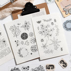 Vintage clear stamp sheet on a clipboard with stamped botanical impressions – journaling supplies flat lay