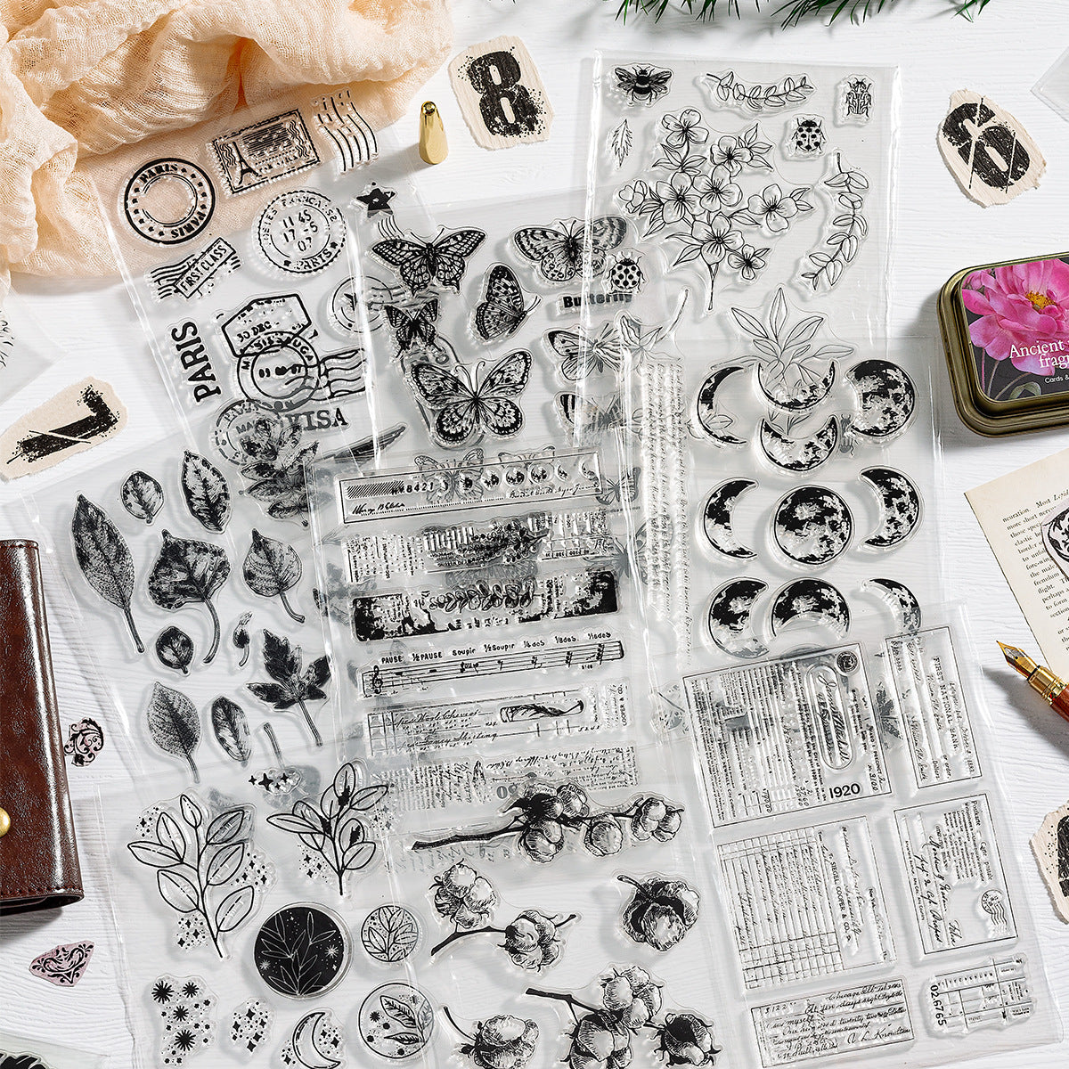 Vintage clear stamp collection – transparent silicone stamp sheets with stamped botanical and postmark impressions on white
