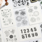 Vintage numbers and snowflake clear stamp sheets with stamped digits 12345 on paper