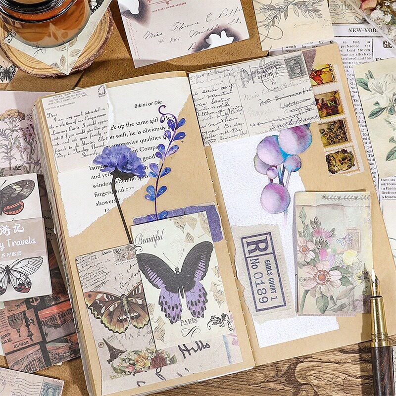 Vintage butterfly and floral ephemera paper layered in junk journal spread with stamps and handwritten notes