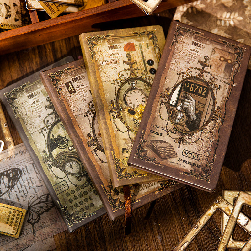 A stack of the four vintage hardcover notebooks available in the journaling kit. Each cover features intricate Victorian-era designs, including antique typewriters, pocket watches, and classic typography.