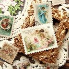 Vintage angel postage stamp stickers arranged with lace doilies – celestial cherub designs on aged paper