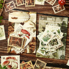 Vintage mushroom postage stamp stickers scattered on a wooden desk – die-cut perforated edges, 50 unique pieces per pack
