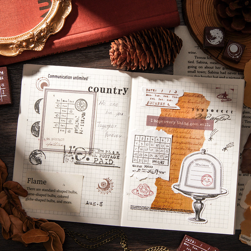 An aesthetic dark academia bullet journal spread using the Moonlight Starlight stamp set. Features crisp black ink impressions of vintage postmarks, moon phases, and retro calendars layered over torn kraft paper and grid pages.