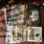 Close-up of dark academia ephemera pieces – aged paper textures, botanical prints and kraft hang tags
