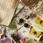 Vintage collage materials with yellow butterfly cutouts, lace-paper doily and aged sheet music – Whispers of Time ephemera pack