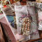 Hand holding the Whispers of Time ephemera pack – 140 mixed pieces of vellum, paper and stickers visible inside