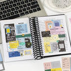 using writable planner stickers at desk with laptop budget and schedule tracking sheets