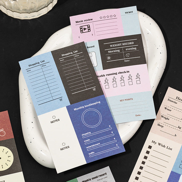 	writable planner sticker sheets arranged on tray color block budget and habit layouts
